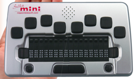 A small silver Braille keyboard with 8 keys in 2 arcs on the top, 2 keys in a row with the touch keys, 1 key below those on the right and left, each, and 2 keys in the center. There is a speaker at the top middle between the arcs.