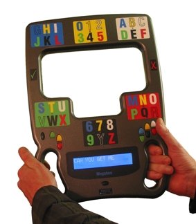 Person holding MegaBee with stickers along frame of device with pictures of letters and numbers. Controls located near handles where thumbs would rest.
