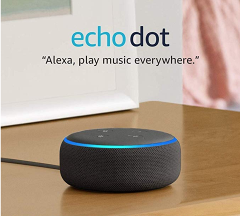 A small, black, and round device roughly the size and shape of a small alarm clock.. A quote reads, "Alexa, play music everywhere."