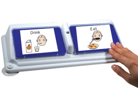 Rectangular white and blue device with two halves, each featuring a large rectangular button with space for an image to be attached. The left button features a white card with an illustration that says "Drink." The button on the right features an illustration that says "Eat." A hand is shown pressing it.